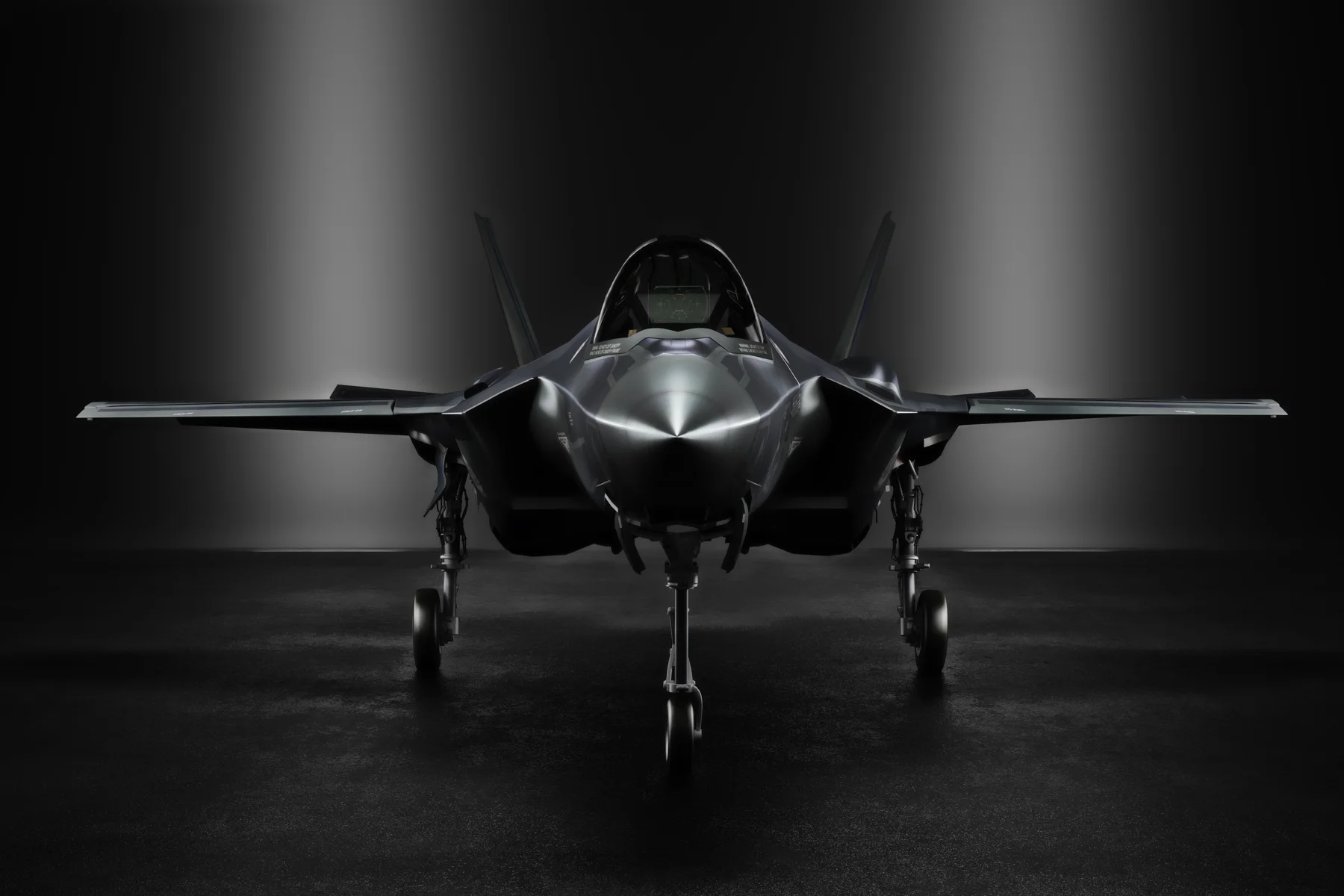 Front view of a stealth aircraft in a dark hangar