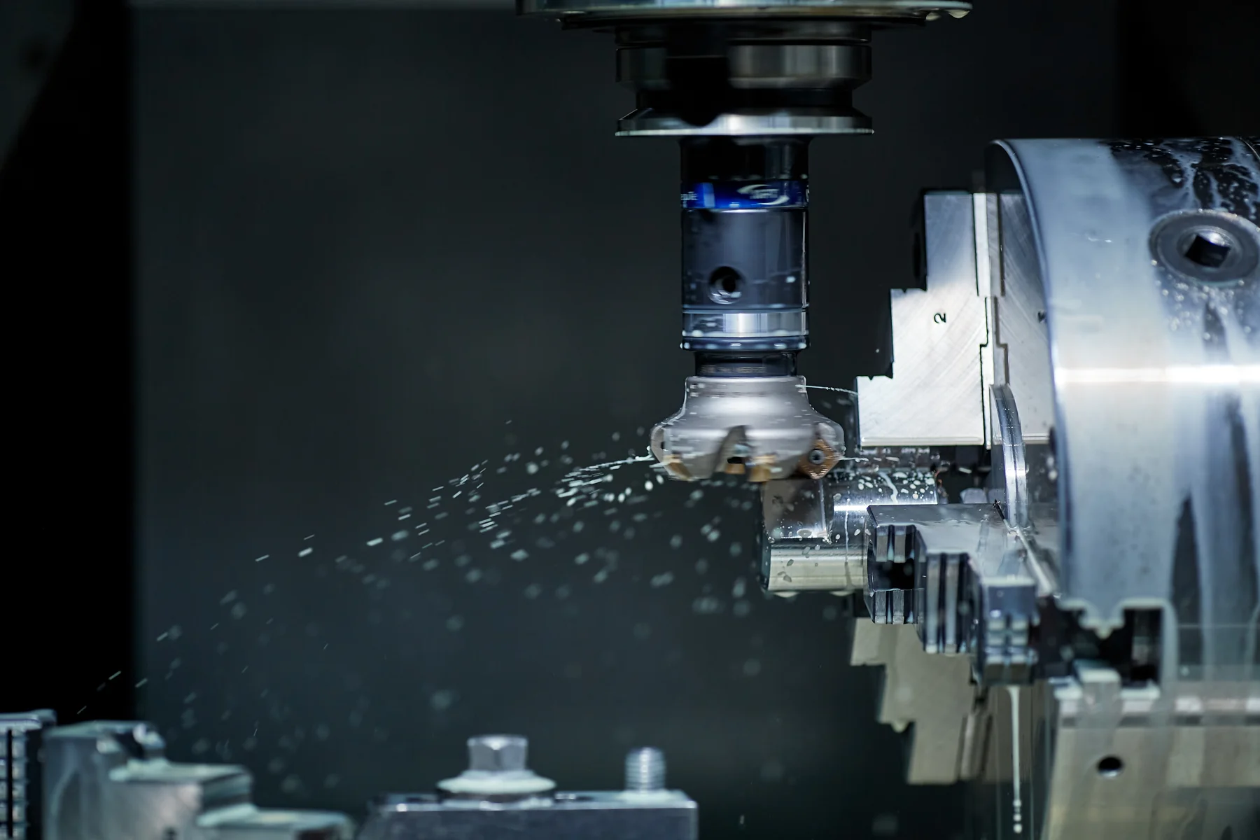 A milling machine cutting a metal component
